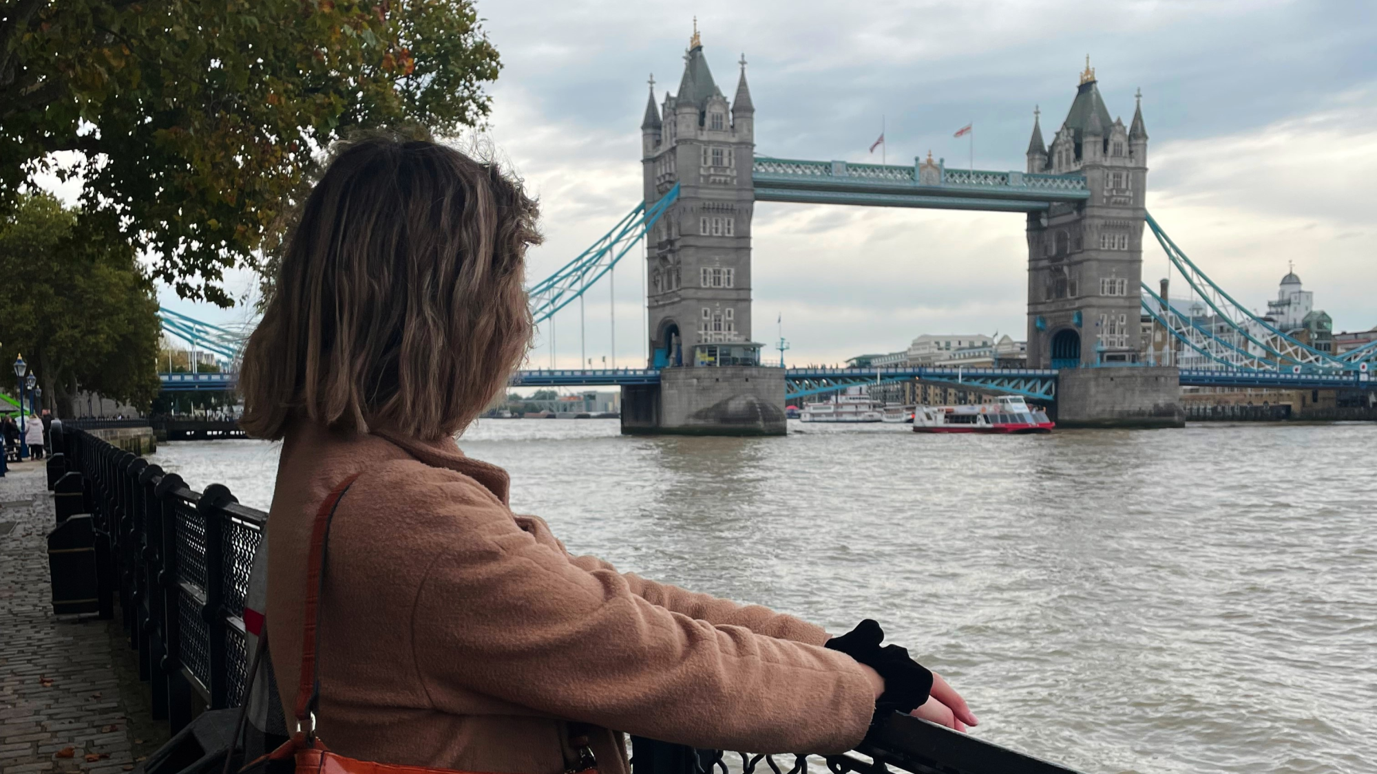 Angela in front of the Tower Bridge, London.