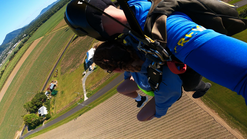 girl skydiving before landing