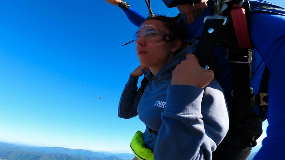 girl parachuting during skydiving in cairns.