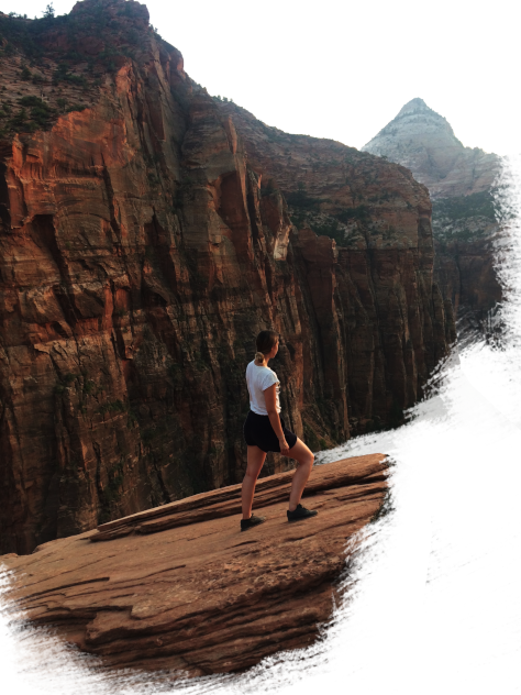 The slowtravelista standing in front of a cliff in Zion National Park